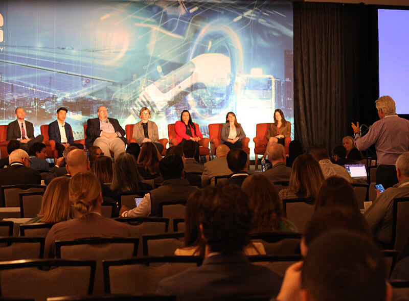 Audience member speaking to load flexibility professionals during a PLMA conference