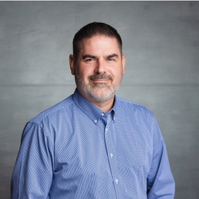 Clay Monroe, Cascade Energy. Headshot of a middle-aged man with a short beard wearing a blue button-down shirt.